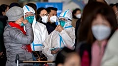 Travellers stand in line to check in for a Cathay Pacific flight to Hong Kong at Beijing Capital International Airport, 15 January 2023