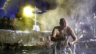 A man bathes in water during a traditional Epiphany celebration as the temperature dropped to about -12 degrees near the Achairsky monastery in Russia.