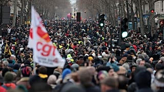 Protesters march during a demonstration against pension changes in Paris. Workers in many French cities took to the streets Thursday to reject proposed pension changes.