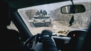A Ukrainian tank with soldiers is seen through a car window close to the frontline near Kremenna in the Luhansk region, 15 January 2023