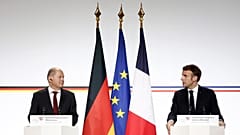 German Chancellor Olaf Scholz and French President Emmanuel Macron attend a joint press conference.