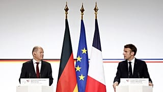 German Chancellor Olaf Scholz and French President Emmanuel Macron attend a joint press conference.