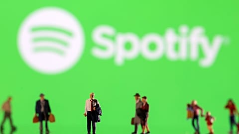 Small figurines displayed in front of the Spotify logo, February 11, 2022. 