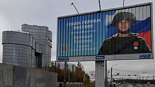 A poster displaying a Russian soldier with a slogan reading 'Glory to the Heroes of Russia' near the 'PMC Wagner Centre' in Saint Petersburg