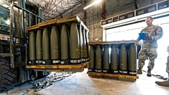 US Air Force Staff Sgt. Cody Brown, right, with the 436th Aerial Port Squadron, checks pallets of 155 mm shells ultimately bound for Ukraine, April 29, 2022.