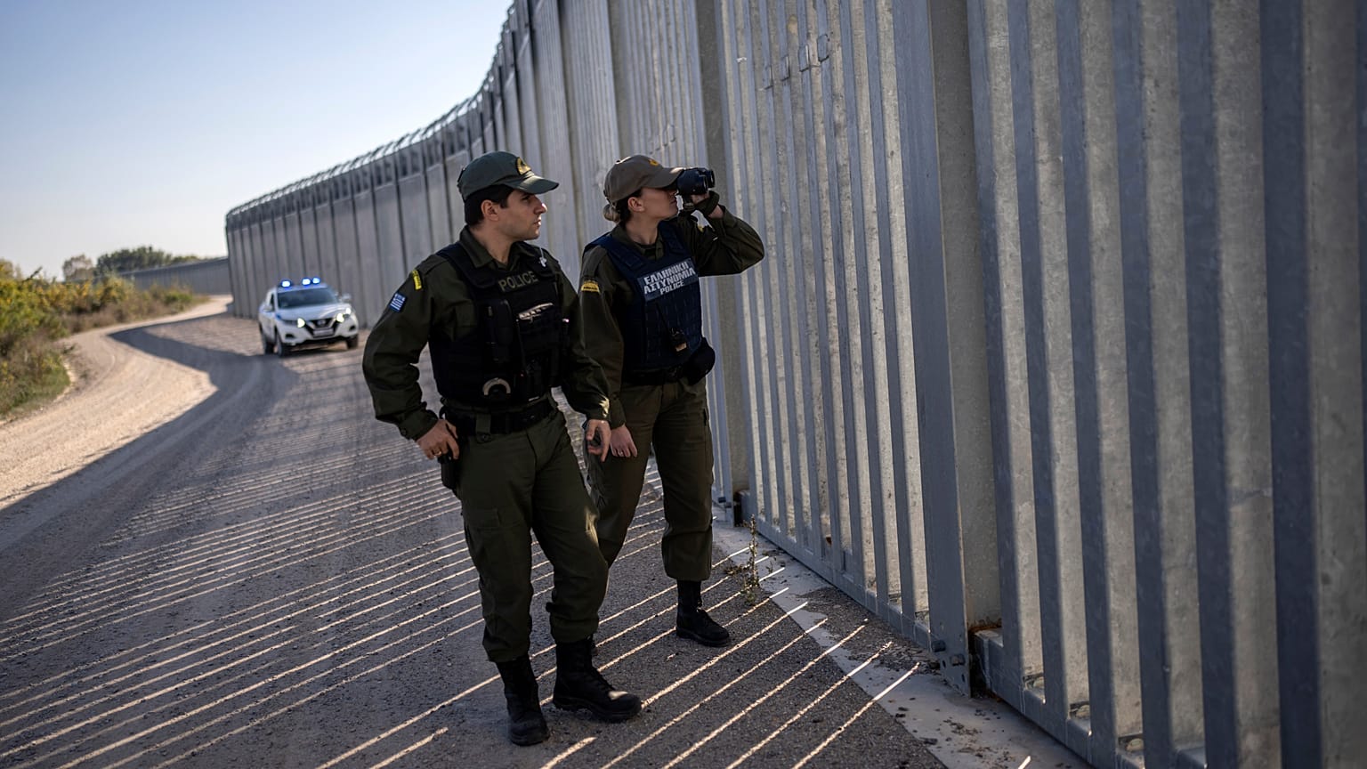 Police border guards patrol along a border wall near the town of Feres, along the Evros River which forms the frontier between Greece and Turkey on Sunday, Oct. 30, 2022.