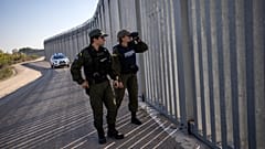 Police border guards patrol along a border wall near the town of Feres, along the Evros River which forms the frontier between Greece and Turkey on Sunday, Oct. 30, 2022.