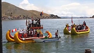 Members of Uru Indigenous community chant and wave Peruvian flags during a protest on boats                                                      floating in lake Titicaca