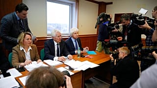 Members of the Moscow Helsinki Group and lawyers talk with journalists in the courtroom 