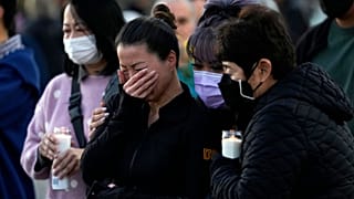 People attend a vigil outside Monterey Park City Hall, blocks from the Star Ballroom Dance Studio where a gunman killed multiple people celebrating the Lunar New Year