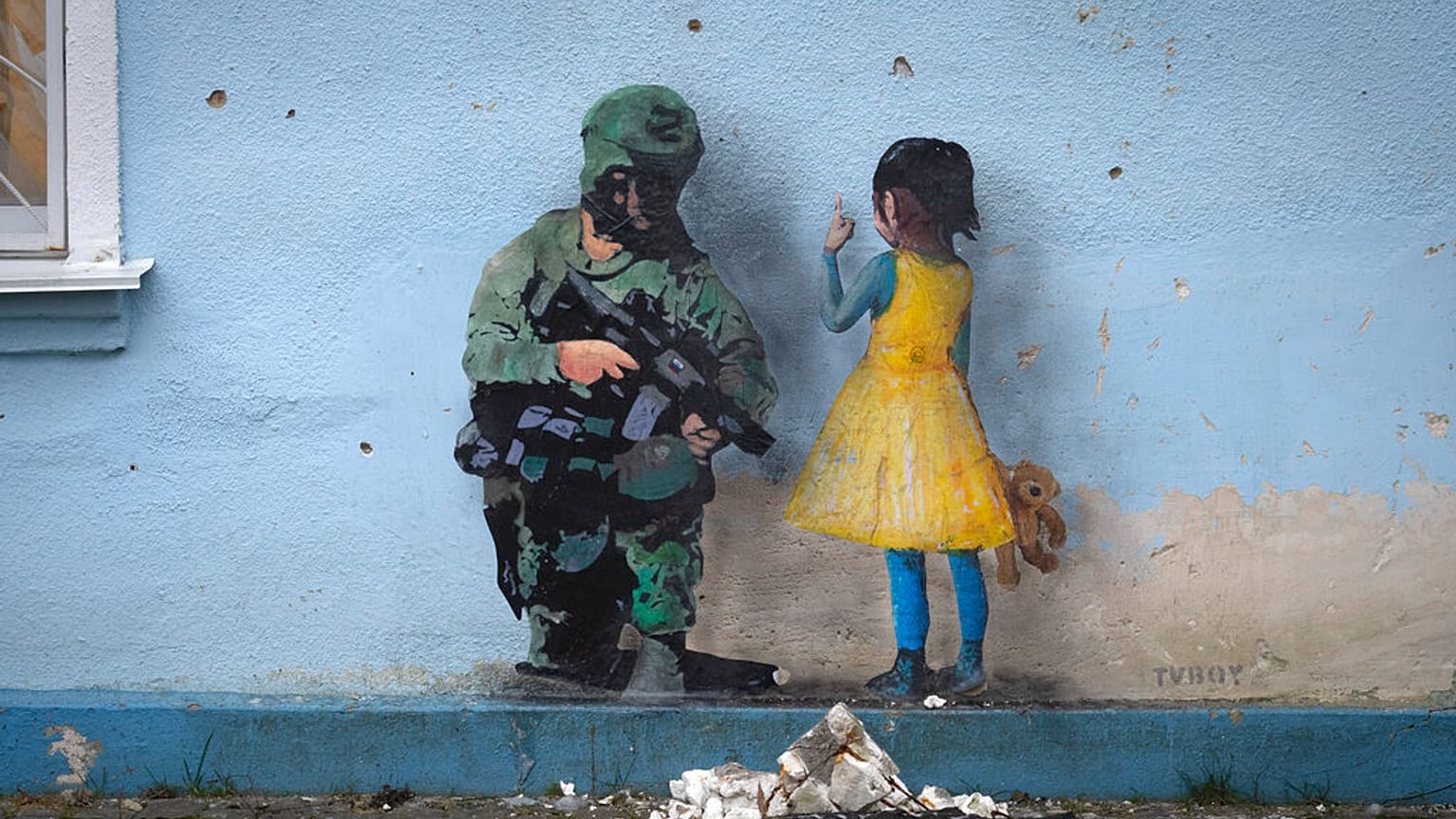 An artwork of the famous street artist TvBoy, in seen on the wall of the house of culture in the town of Irpin, outside Kyiv, Ukraine Monday, Jan. 30, 2023.