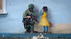 An artwork of the famous street artist TvBoy, in seen on the wall of the house of culture in the town of Irpin, outside Kyiv, Ukraine Monday, Jan. 30, 2023.