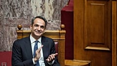 Greek Prime Minister Kyriakos Mitsotakis claps during a parliamentary debate on a motion of censure in Athens, on Friday, Jan. 27, 2023