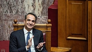 Greek Prime Minister Kyriakos Mitsotakis claps during a parliamentary debate on a motion of censure in Athens, on Friday, Jan. 27, 2023