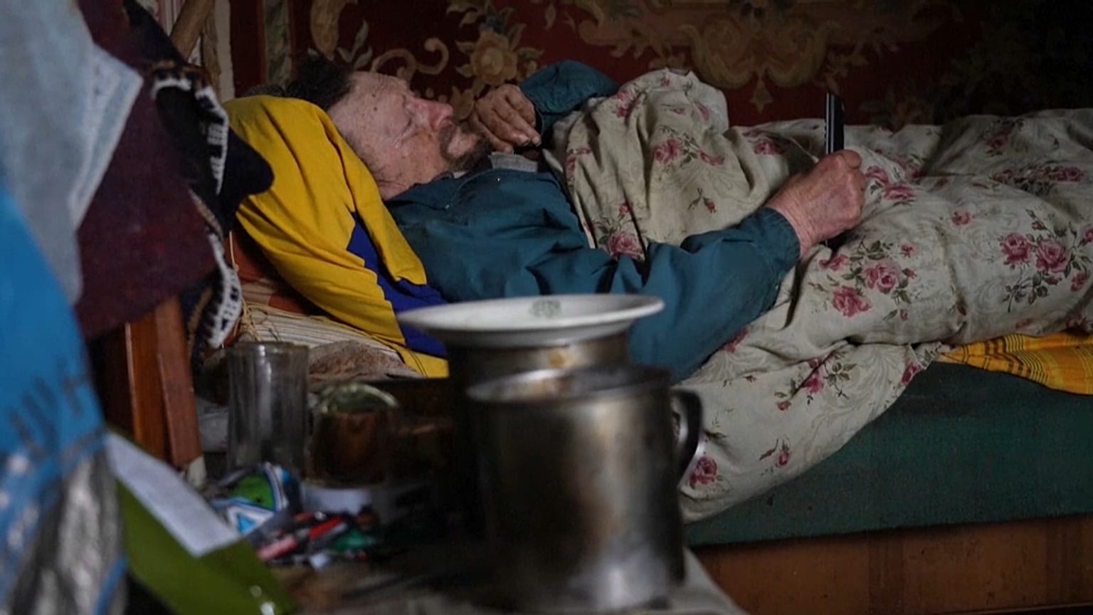 A 83-year old with advanced cancer lying on the sofa in a dark room in Kalynivske.  