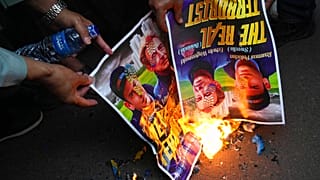 Muslim protesters burn posters during a rally outside the Swedish Embassy in Jakarta, Indonesia, Monday, Jan. 30, 2023.