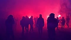 Demonstrators walk through flare smoke during a demonstration against plans to push back France's retirement age,Jan. 31, 2023 in Paris. 