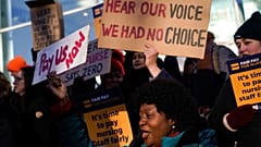 FILE: Nurses hold banners and placards as they picket during a strike over pay, outside the University College Hospital, in London, Wednesday, Jan. 18, 2023.