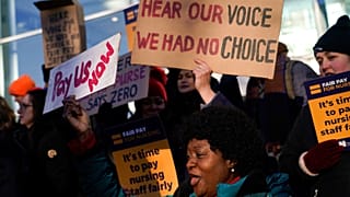 FILE: Nurses hold banners and placards as they picket during a strike over pay, outside the University College Hospital, in London, Wednesday, Jan. 18, 2023.
