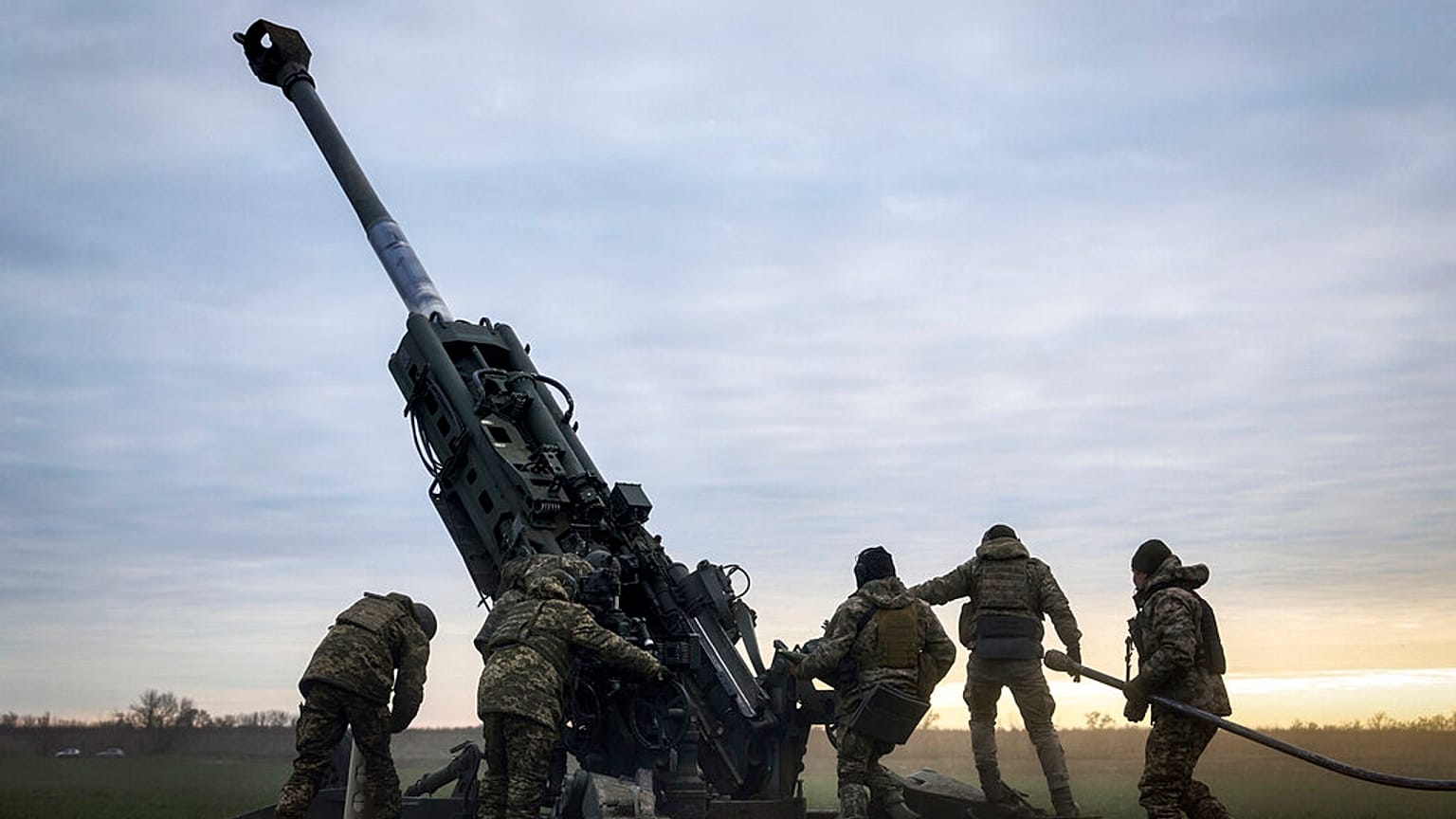 Ukrainian soldiers prepare a U.S.-supplied M777 howitzer to fire at Russian positions in Kherson region, Ukraine, Jan. 9, 2023. 