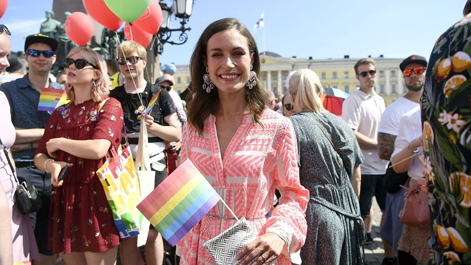 FILE: Finnish Prime Minister Sanna Marin holds a rainbow flag as she takes part in the 2022 Helsinki Pride march in Helsinki, Finland, on July 2, 2022.