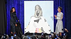 Amy Sherald (R) unveils her portrait of Michelle Obama with the former First Lady herself