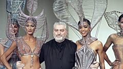 Franco-Spanish fashion designer Paco Rabanne embraces models after the presentation of his spring - summer collection on January 27, 1993 in Paris, France. 