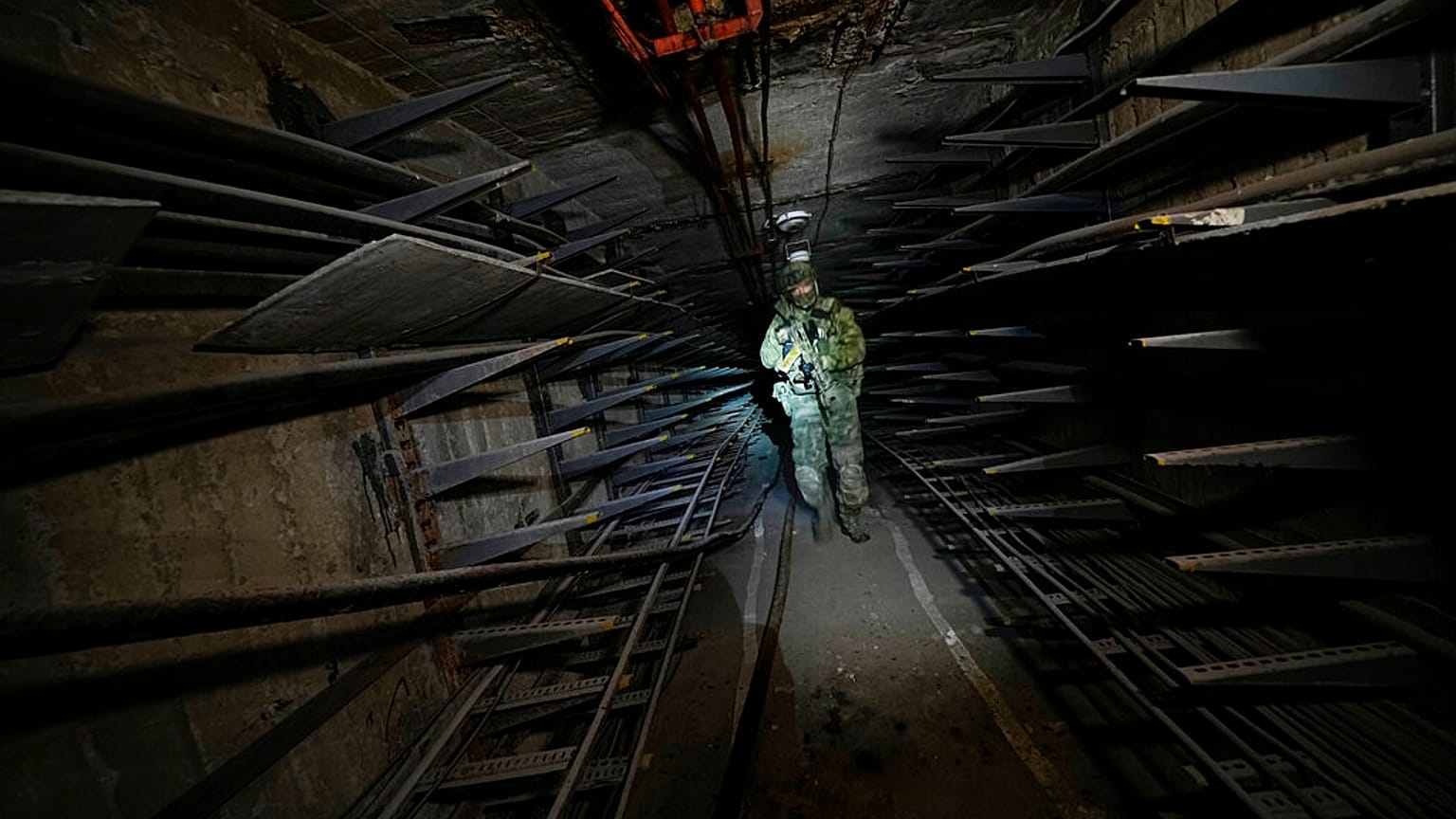 A Russian soldier inspects a corridor in the Azovstal steel mill in Mariupol, in eastern Ukraine, Monday, June 13, 2022.