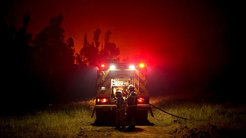 Firefighters prepare to fight flames caused by wildfires in Puren, Chile on Saturday. 