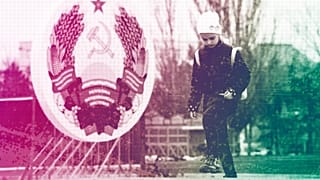 A girl walks past an emblem of the Transnistrian Moldavian Republic in Tiraspol, the capital of the breakaway region of Transnistria, November 2021