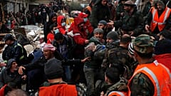 Des secouristes portent une victime du tremblement de terre alors qu'ils fouillent les décombres des bâtiments effondrés à Hama, Syrie, le 6 février 2023.