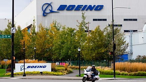 A motorcyclist cruises past the Renton, Boeing plant in Washington state, where 737's are built, 28 Oct 2020