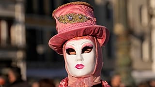 A woman wears a mask in St. Mark's Square during the Venice Carnival.