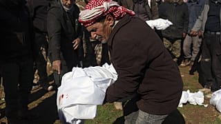 Mourners bury family members who died in a devastating earthquake that rocked Syria and Turkey at a cemetery in the town of Jinderis, Aleppo province, Syria, Feb. 7, 2023.