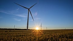 Wind turbines in operation as the sun sets over Hook Moor Wind Farm in Leeds.