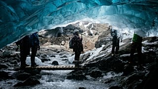 Tourists visit a waterfall ice cave on the Breidamerkurjokull Glacier in Iceland.