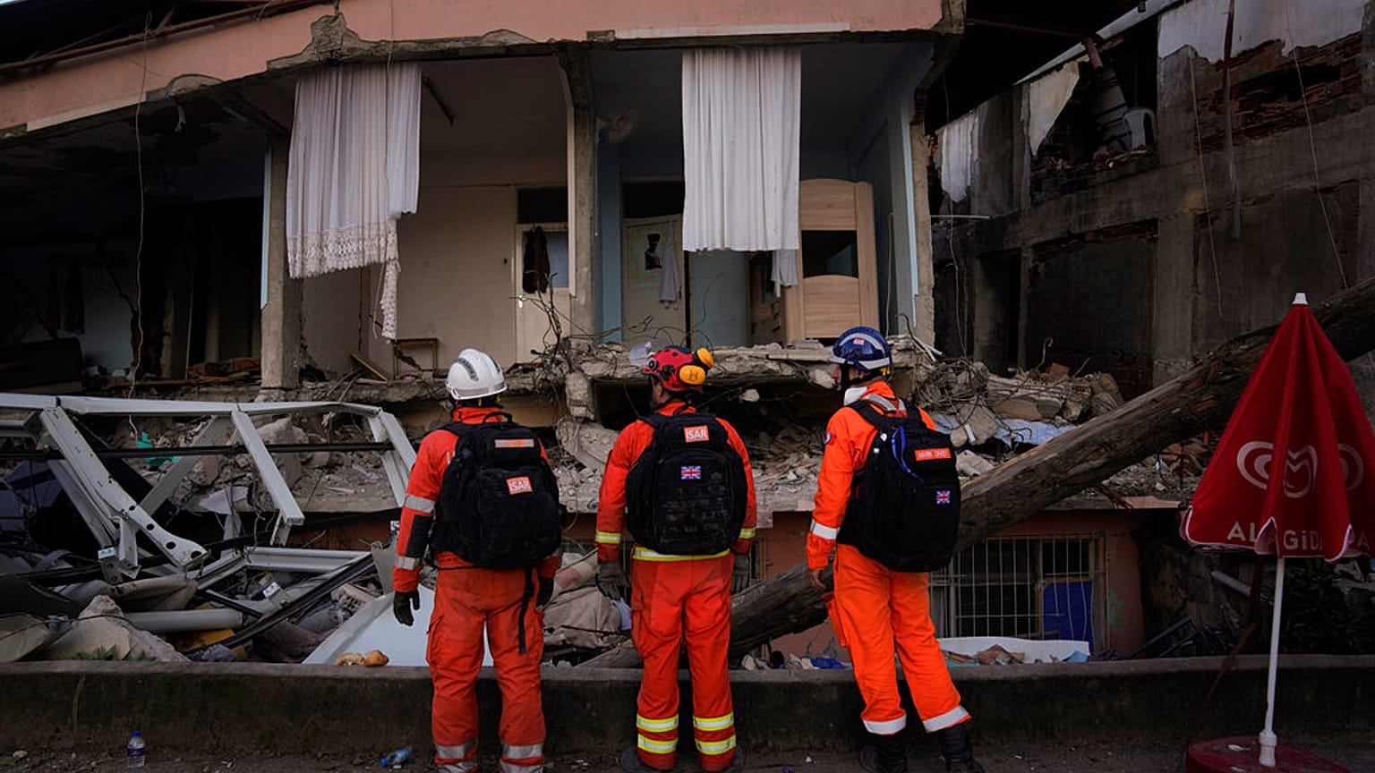 Members of the British rescue team search in a destroyed house in Antakya, southern Turkey.