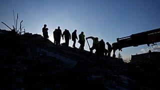 Rescue teams search for people in the rubble of destroyed buildings in Antakya, southern Turkey, Wednesday, Feb. 8, 2023.