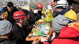 Ayse, a six-year-old girl from Syria who survived under a destroyed building, is carried on a stretcher by rescue teams in Kahramanmaras, Turkey, Saturday, Feb. 11