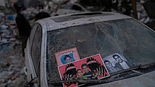 Imagens recuperadas dos escombros de um edifício destruído durante terramoto são colocadas num para-brisas de um carro em Antakya, no sudeste da Turquia