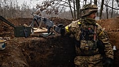 An Ukrainian soldier stands on duty with his machine gun at an undisclosed location in Donetsk region, Ukraine, Wednesday, Nov. 16, 2022.