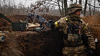 An Ukrainian soldier stands on duty with his machine gun at an undisclosed location in Donetsk region, Ukraine, Wednesday, Nov. 16, 2022.