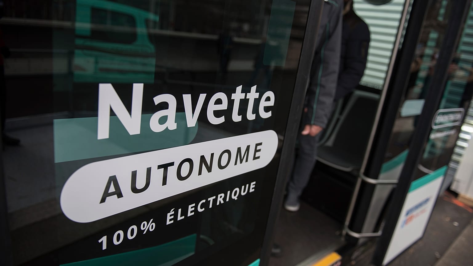 Inscription reading "Autonomous shuttle" is seen on an experimenting self-driving shuttle linking two train stations, Tuesday, Jan. 24, 2017 in Paris.