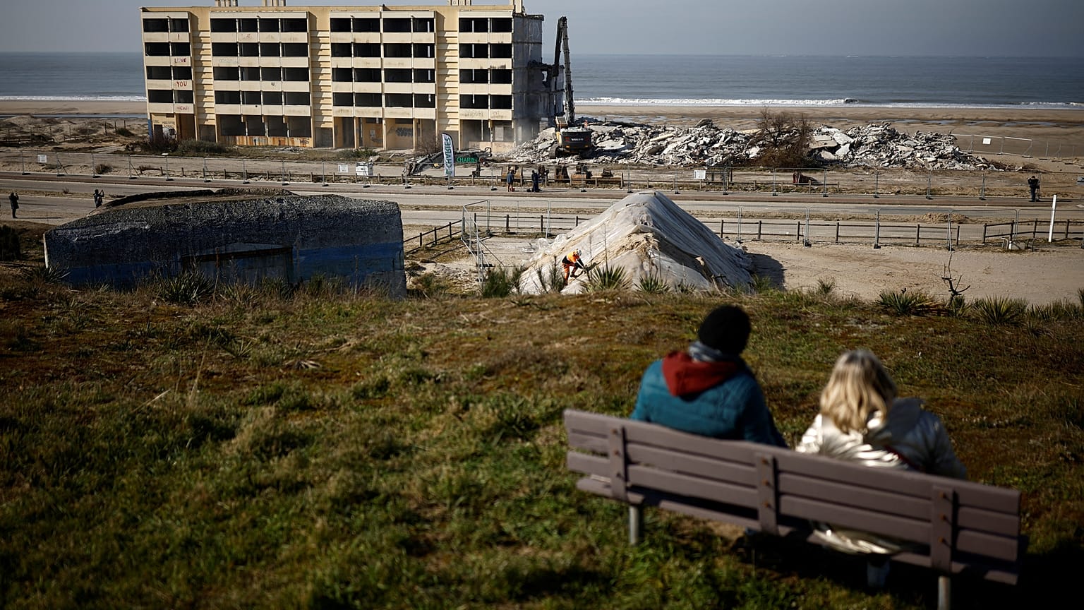 People look at the demolition of the Signal building, a seaside block of flats which had to be evacuated in 2014 due to erosion on the Atlantic Ocean coast.
