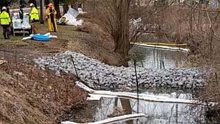 Cleanup continues in a stream in East Palestine Park in East Palestine, Ohio