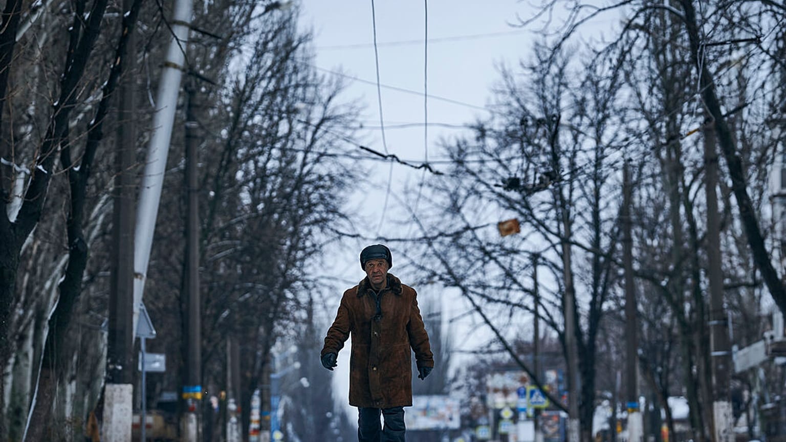 A local resident walks along a street in Bakhmut, Donetsk region, Ukraine, Tuesday, Feb. 14, 2023