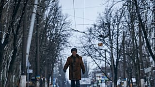 A local resident walks along a street in Bakhmut, Donetsk region, Ukraine, Tuesday, Feb. 14, 2023