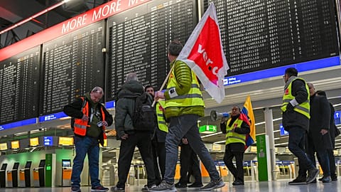 Airport employees in strike vests are on the move in Departure Hall B in Terminal 1 of Frankfurt Airport in Munich, Germany, 17 February 2023