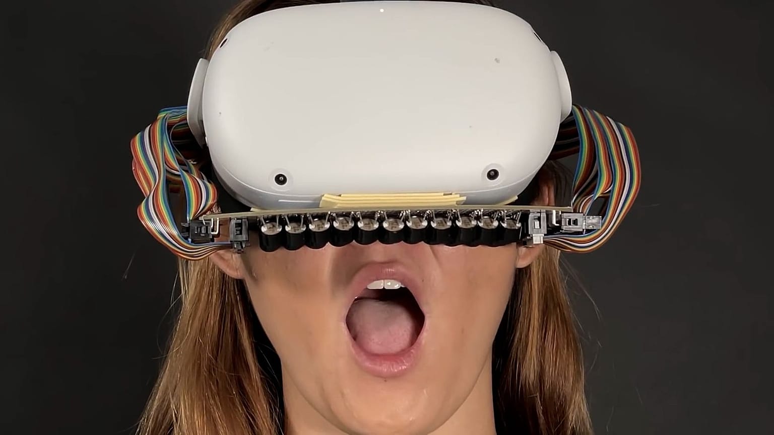 Researchers have developed a VR headset that sends taps and vibrations to the mouth to enhance haptic sensations like the feeling of rain, wind or smoke.