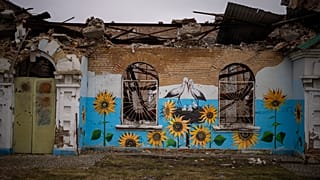 A painting decorates the façade of a house damaged during the Russian occupation in Bucha, near Kyiv,